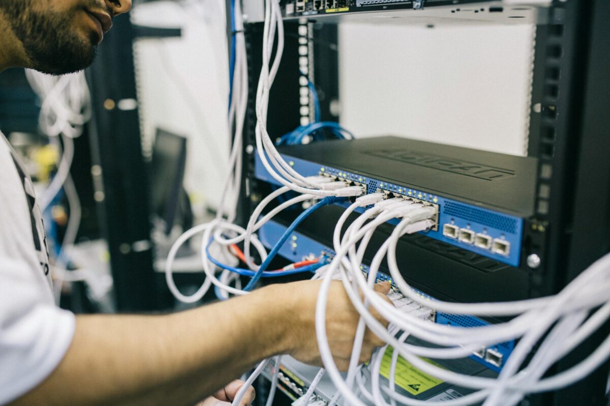 Ilustrasi Layanan Hosting Web (Foto oleh Field Engineer: https://www.pexels.com/id-id/foto/insinyur-elektronik-memperbaiki-kabel-di-server-442150/)